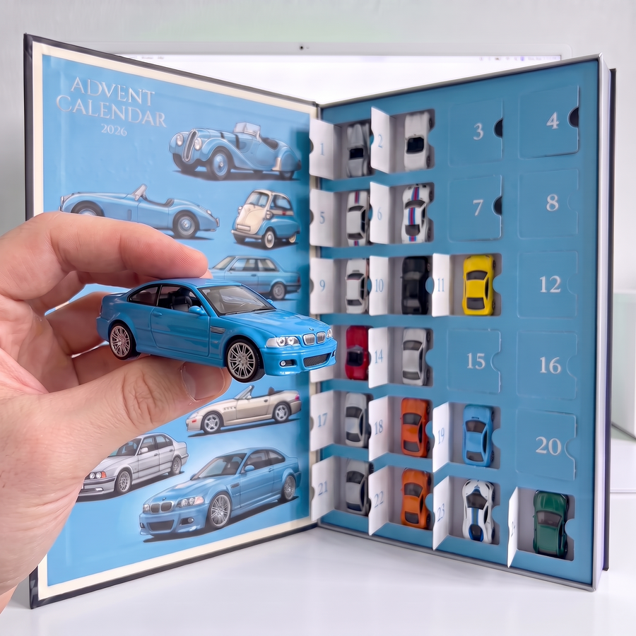 Hand holding a light-blue die-cast coupe in front of the open advent calendar